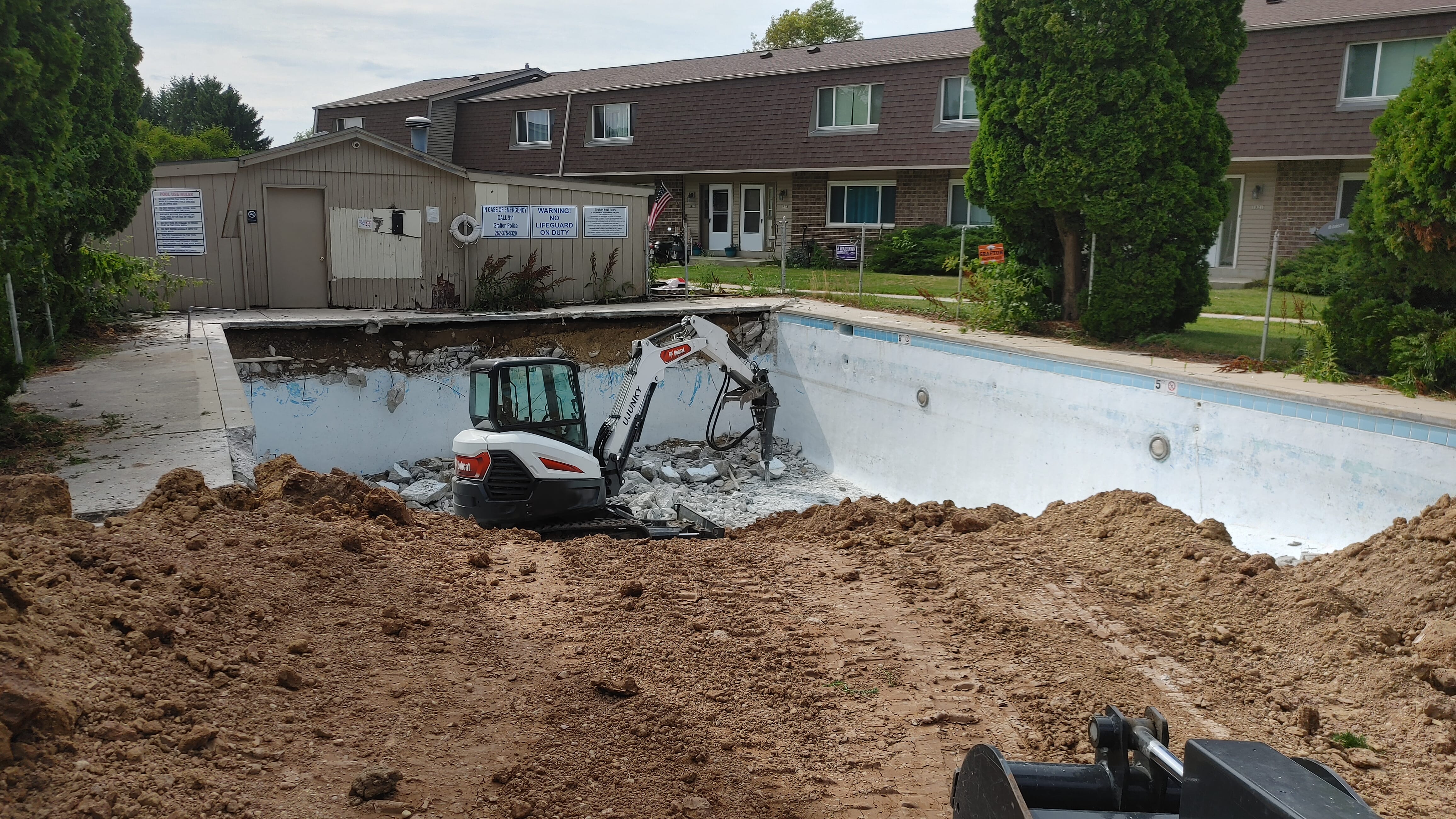 Pool demolition concrete breaking action shot in Milwaukee
