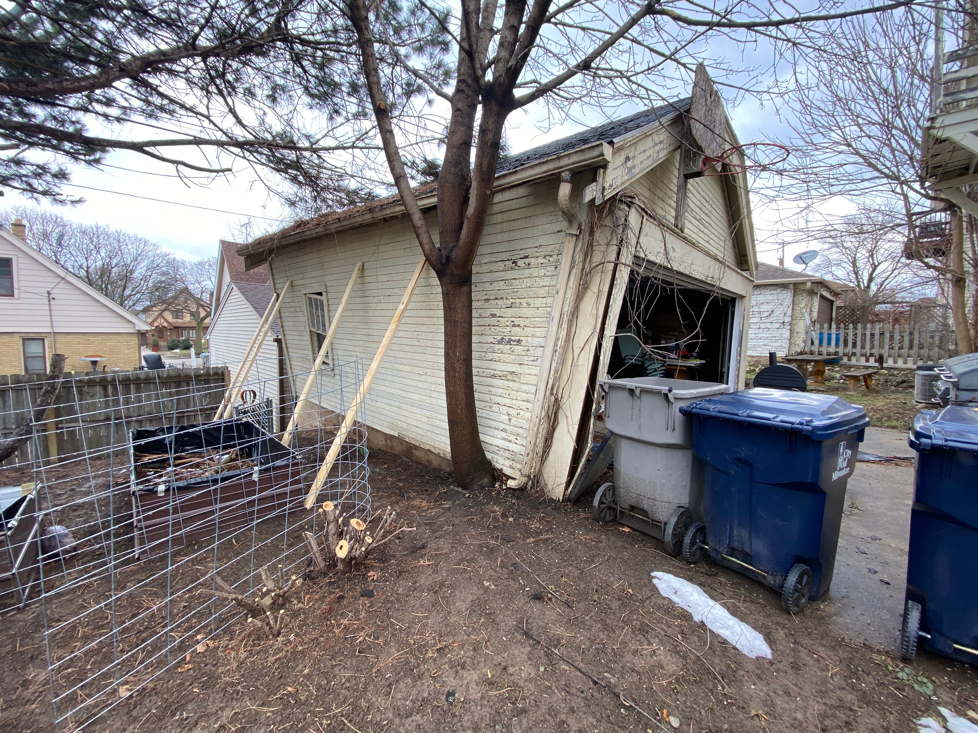 Leaning unsafe garage before demolition in Milwaukee