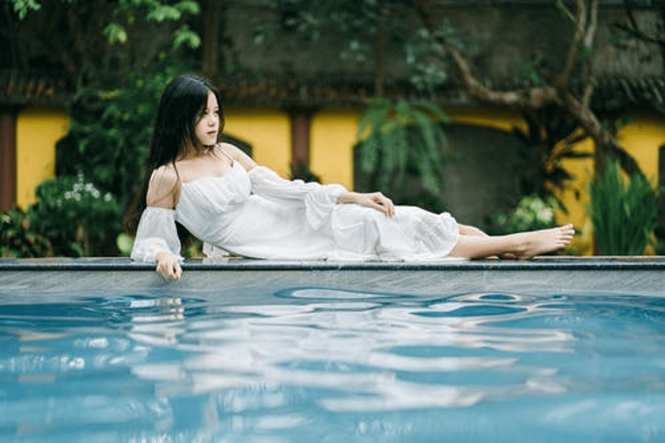 a woman lying on the edge of the pool